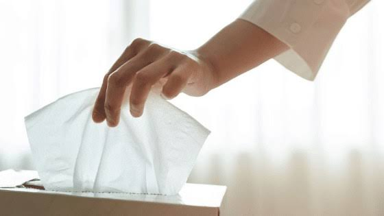 Hand pulling non-woven dry wipe from tissue box